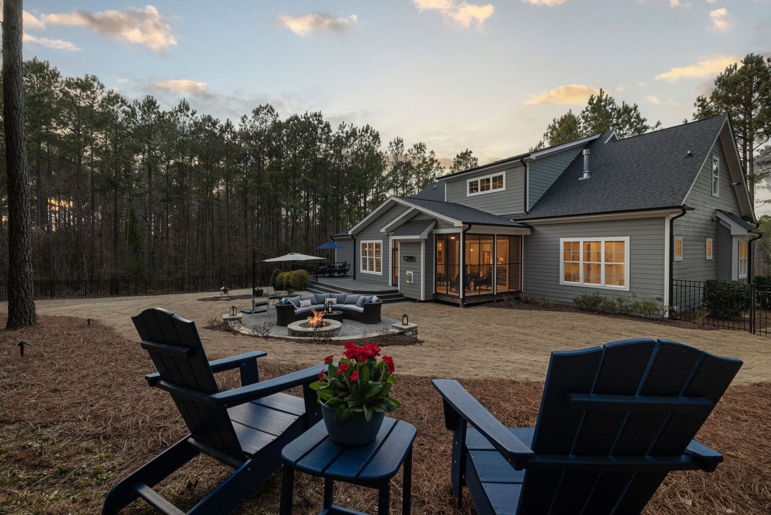 Backyard with fire pit and seating at dusk