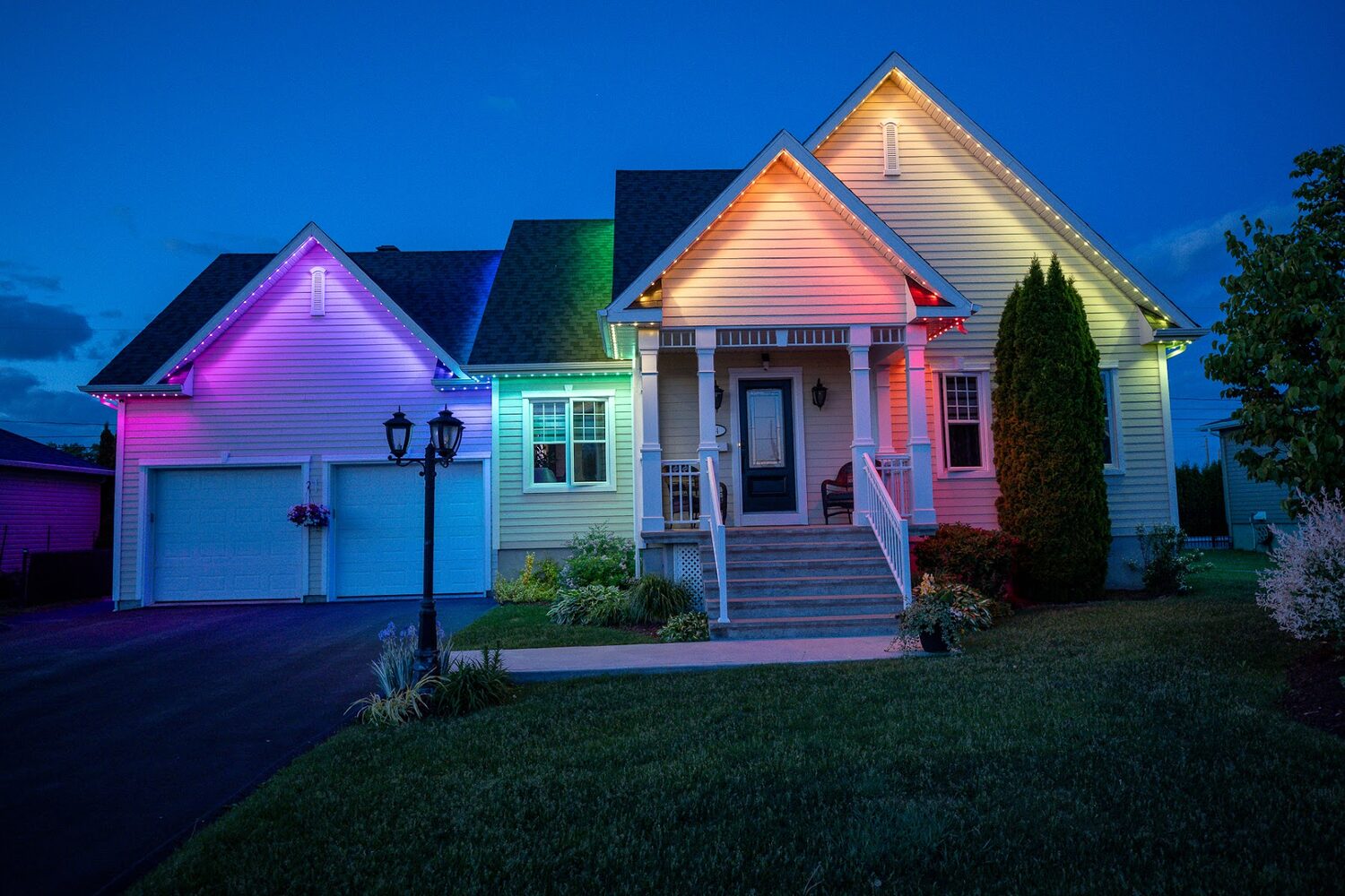 Home lit in blended pink, green and blue across the roofline