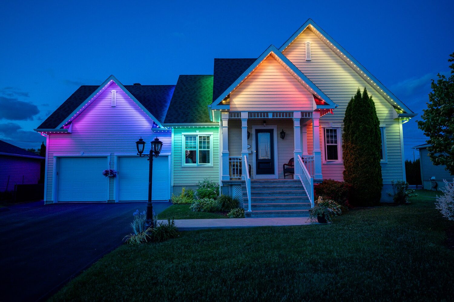 Home lit in soft pastel colours across the gables and garage