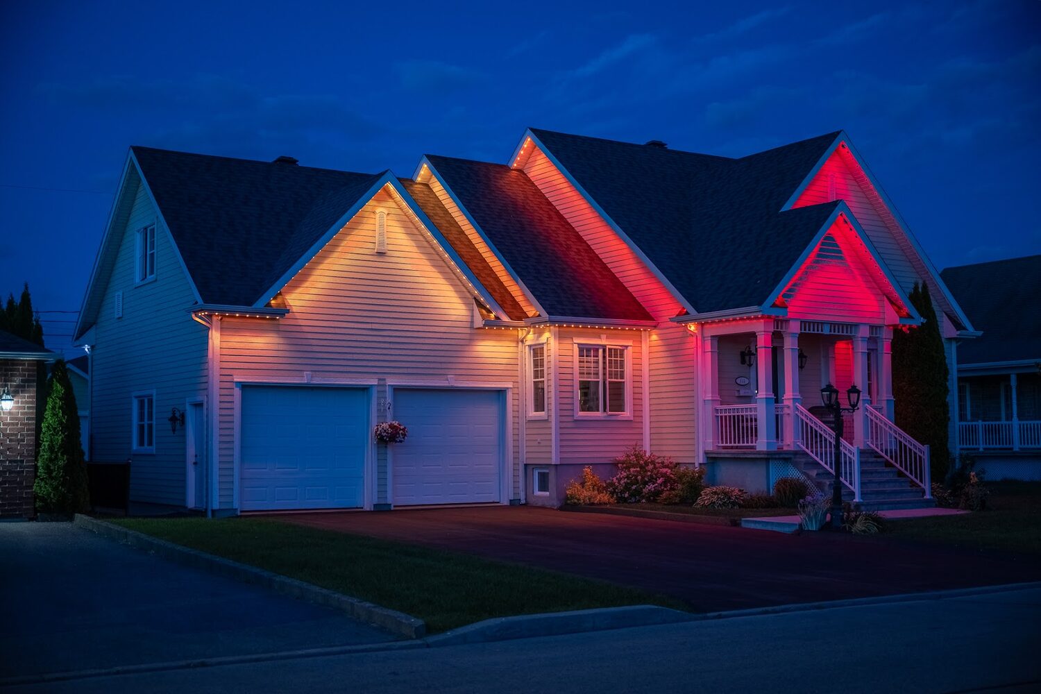 Home lit in red and warm amber across the roofline