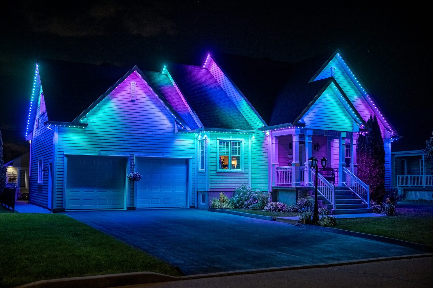 Home lit in teal and violet with the peaks picked out separately