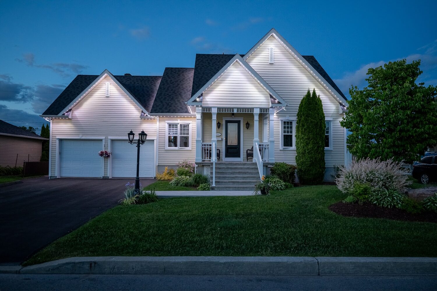 Home lit in warm white along the roofline at dusk