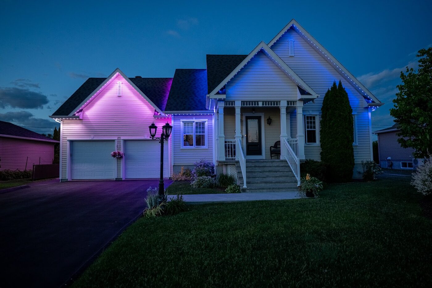 Modern home lit along its roofline at dusk