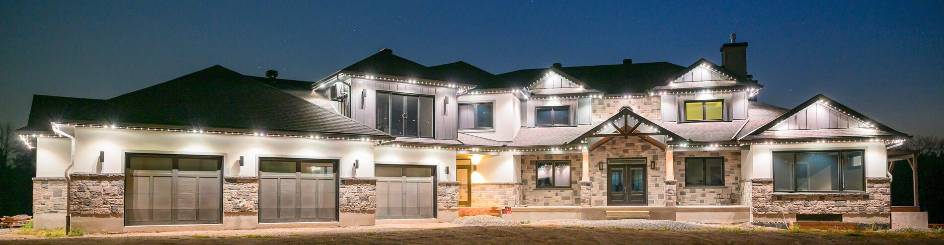 Large home with its roofline picked out in warm white pixels