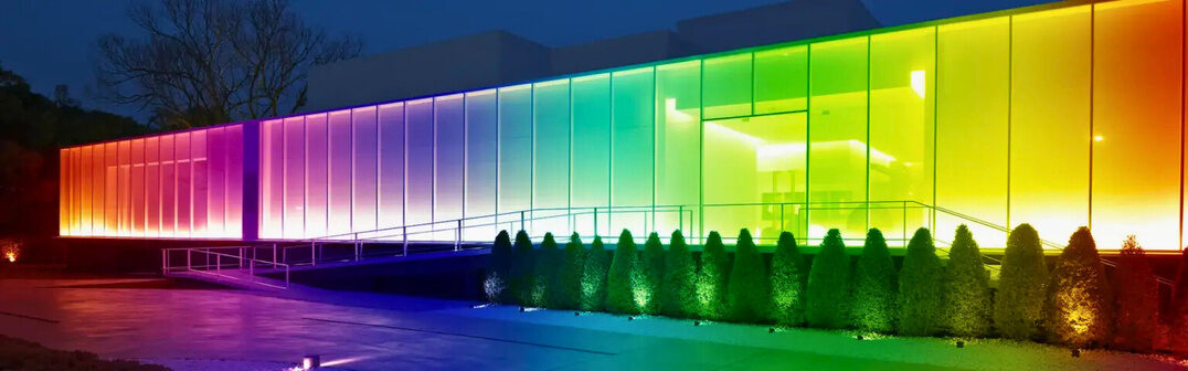 Long glass commercial facade washed in a full colour gradient