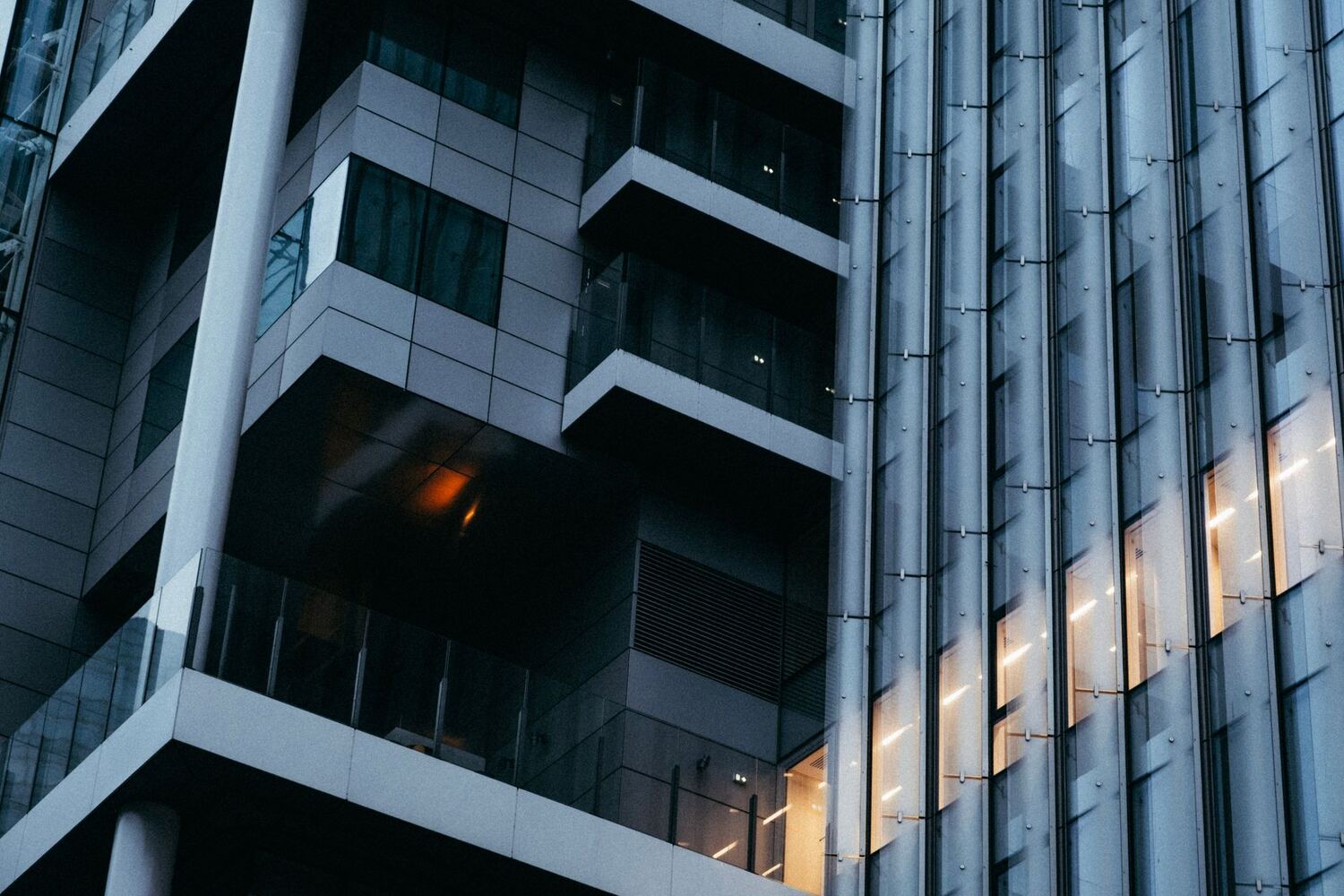 Glass office building facade lit at dusk