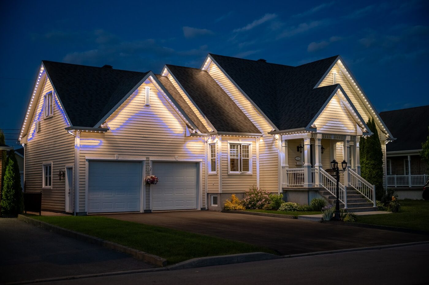 Modern home with its roofline lit in warm white