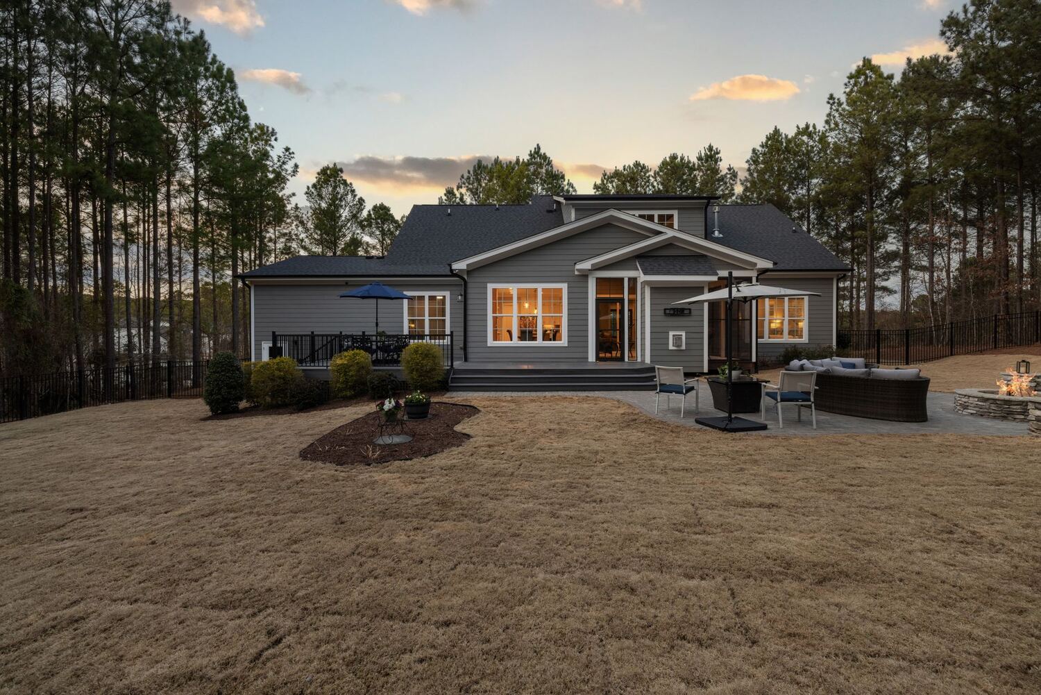 Modern home and back yard lit at sunset